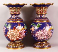 A PAIR OF CHINESE CLOISONNE VASES - with a deep royal blue ground depicting native flora and