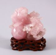AN EARLY 20TH CENTURY CHINESE CARVED ROSE QUARTZ FIGURE OF LION DOGS, the two dogs playing with