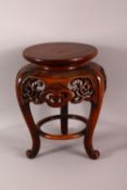 A JAPANESE CARVED HARDWOOD TRIPOD STAND - with a carved frieze of floral form, housing a vase or