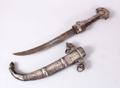 A GOOD EASTERN WHITE METAL JAMBIYA DAGGER, with onlaid white metal decoration, with handles and