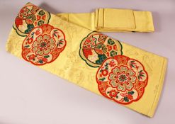 A FINE JAPANESE SILK EMBROIDERED FUKURO OBI TIE - upon a yello ground with red and green details
