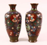 A PAIR OF 19TH CENTURY CHINESE CLOISONNE VASES - with floral panel decoration upon a dark ground