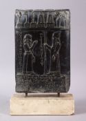 A MESOPOTAMIAN BABYLONIAN STYLE CARVED BLACK TABLET, carved with two figures and objects, with