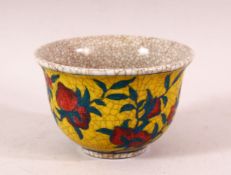 A YELLOW GROUND CRACKLE GLAZE TEA BOWL, decorated with peach tree, the base with six character mark,