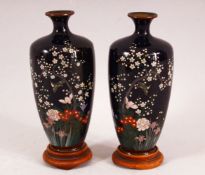 A FINE PAIR OF JAPANESE MEIJI PERIOD CLOISONNE VASES AND STANDS, decorated with birds amongst native