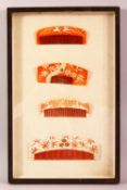 A FRAMED SET OF 19TH CENTURY JAPANESE CARVED & STAINED IVORY COMBS, each with red staining and