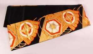 A FINE JAPANESE SILK EMBROIDERED FUKURO OBI TIE - upon a black ground with red orange & green