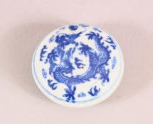 A CHINESE BLUE AND WHITE CIRCULAR PORCELAIN BOX, the inside painted with erotic scenes, four