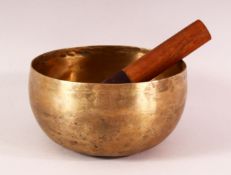 A 19TH CENTURY CHINESE TIBETAN BRASS MUSIC BOWL AND STICK - 17CM