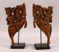 A PAIR OF 19TH CENTURY SOUTH INDIAN CARVINGS OF HORSE RIDERS, both elevated on wooden stands, both