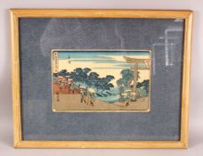 A JAPANESE FRAMED WOOD BLOCK PRINT - depicting figures walking over a bridge, 59cm x 46cm