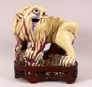 A CHINESE FLAMBE / CRACKLE GLAZE FIGURE OF A DOG & STAND - crackle glaze with flambe highlights,