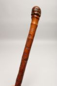 AN AFRICAN CARVED WALKING STICK 2ft 10ins long