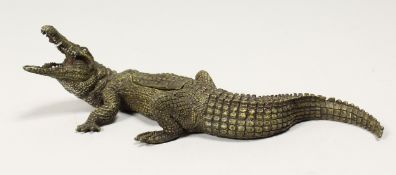 A VIENNA STYLE COLD PAINTED BRONZE OF A CROCODILE, part of the back opening to reveal a female