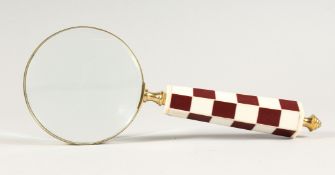 A MAGNIFYING GLASS WITH CHEQUERED HANDLE.