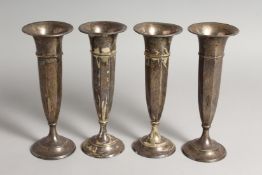 FOUR VERY SIMILAR STERLING SILVER FLOWER VASES 8ins high.