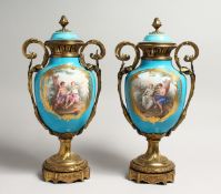 A SUPERB LARGE PAIR OF SEVRES PORCELAIN ORMULO MOUNTED CIRCULAR VASES AND COVERS, painted with