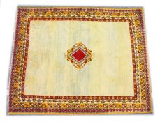 A MOROCCAN WOOL CARPET, 19TH CENTURY, cream ground with a central diamond shape design, with a