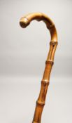 A RUSTIC WALKING STICK 2ft 7ins long