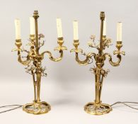 A GOOD PAIR OF FRENCH BRONZE THREE BRANCH CANDELABRA with scrolling arms and porcelain flowers 25ins