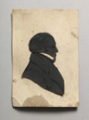 AN EARLY 20TH CENTURY SILHOUETTE PORTRAIT BUST OF A GENTLEMAN, loosely mounted on a card printed