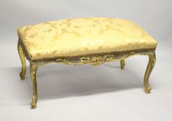 A GILT FRAMED STOOL UPHOLSTERED IN GOLD DAMASK. 3ft 2ins long x 1ft 8ins wide x 1ft 8ins high.