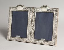 A PAIR OF SILVER PHOTOGRAPH FRAMES, with gadrooned borders 9ins x 5.5ins