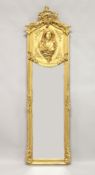 A DECORATIVE NARROW GILT FRAMED MIRROR the upper section decorated with the bust of a lady 5ft 10ins