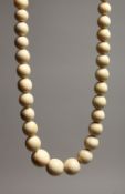 A GOOD GRADUATED IVORY BEAD NECKLACE on ninety seven beads. 36ins long