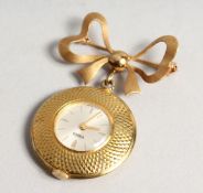 A URBEX 18CT GOLD NURSE'S FOB WATCH topped with a bow brooch