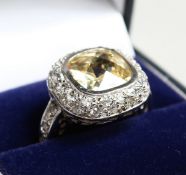 A SILVER CZ AND YELLOW RING