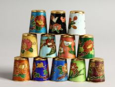 TWELVE VARIOUS COLOURED SILVER AND ENAMEL THIMBLES