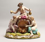 A GOOD 19TH CENTURY CONTINENTAL POTTERY GROUP depicting the grape harvest, one sitting on a