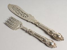 A PAIR OF VICTORIAN SILVER PIERCED AND ENGRAVED FISH SERVERS London 1854 maker, J. C.