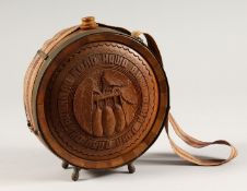 A RUSSIAN CARVED WOOD AND METAL BOUND CIRCULAR WATER FLASK 7ins diameter.