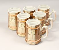 A SET OF SIX RUSSIAN PORCELAIN TANKARDS No. 1 - VI., simulating wooden tankards, 6ins high.
