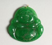 A JADE BUDDHA PENDANT with gold rings 2ins