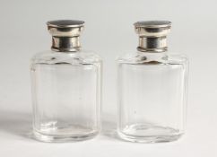 A PAIR OF GLASS SCENT BOTTLES with silver and tortoiseshell tops Initial 'J' Birmingham 1928