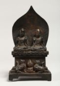 A CHINESE BRONZE SHRINE, cast with a pair of seated figures 8.5ins high