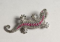 A SILVER MARCASITE AND RUBY LIZARD BROOCH.