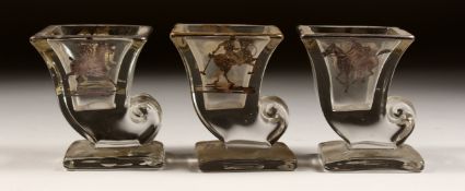 A SET OF THREE SILVER OVERLAY MOULDED GLASS SMALL VASES, decorated with polo players on horseback.
