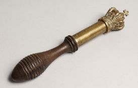 A 19TH CENTURY TURNED WOOD AND BRASS TIPSTAFF, the top as a crown with a cross. 7.5ins long.