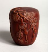 A SMALL JAPANESE CARVED WOOD BOX AND COVER, carved with fruit 2.75ins