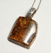 A SILVER AND AMBER PENDANT