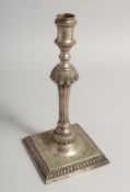 A SINGLE GEORGE II CAST CANDLESTICK by John Care on a square gadrooned base 10.5ins high, weight