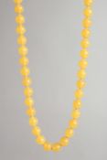 AN AMBER TYPE BEAD NECKLACE with forty two beads