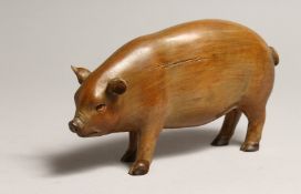 A CARVED WOOD PIG 6ins long