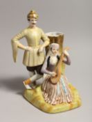A RUSSIAN STYLE PORCELAIN SPILL VASE OF A RUSSIAN MAN, the woman playing a guitar.