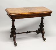 A GOOD VICTORIAN FIGURED WALNUT CARD TABLE, with folding rounded rectangular top, on a pair of