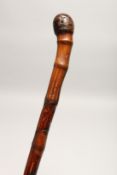 A RUSTIC WALKING CANE 2ft 11ins long